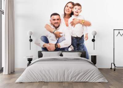 happy family mother, father and son sitting on the floor on white Wall mural